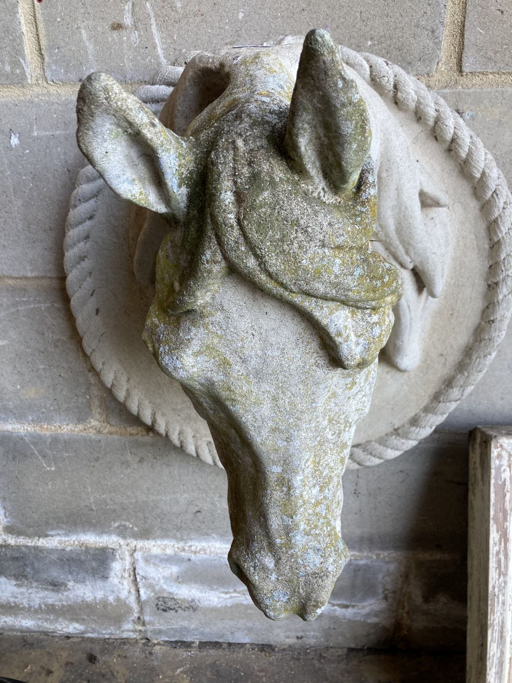 A weathered reconstituted stone model of a horses head, height 60cm